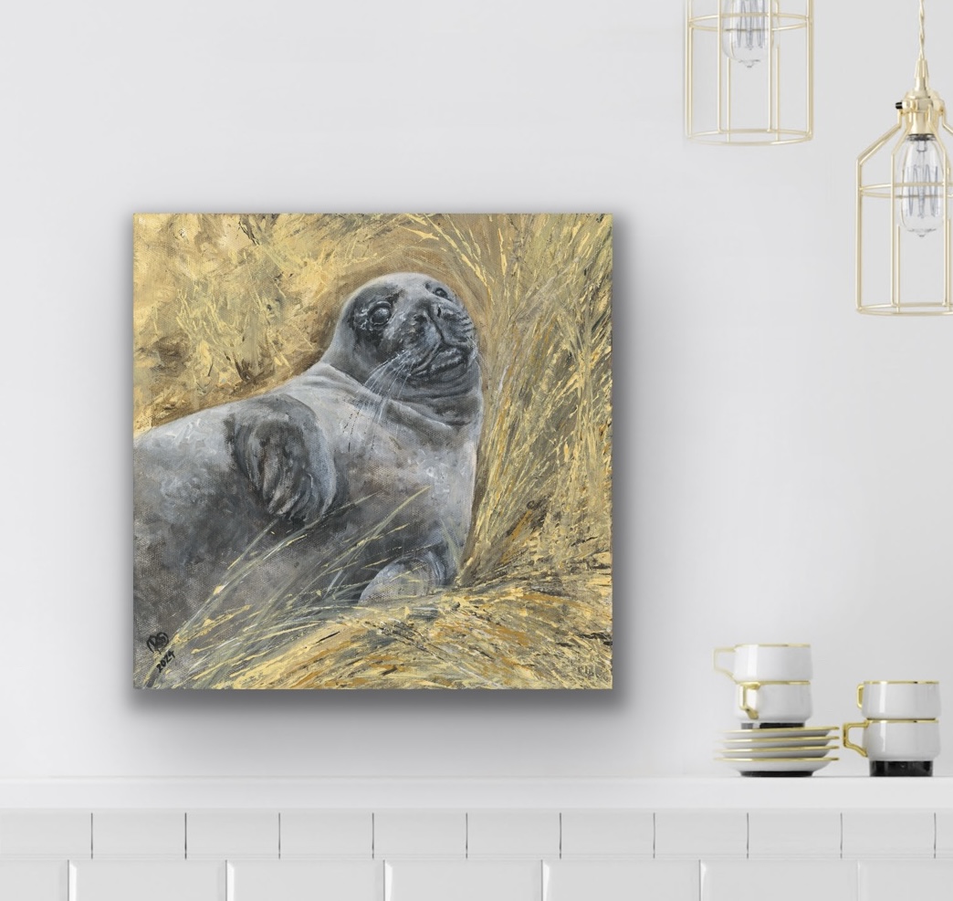 Held seal pup canvas print in a white contemporary kitchen styled above white tiles with brass lights and coffee cups