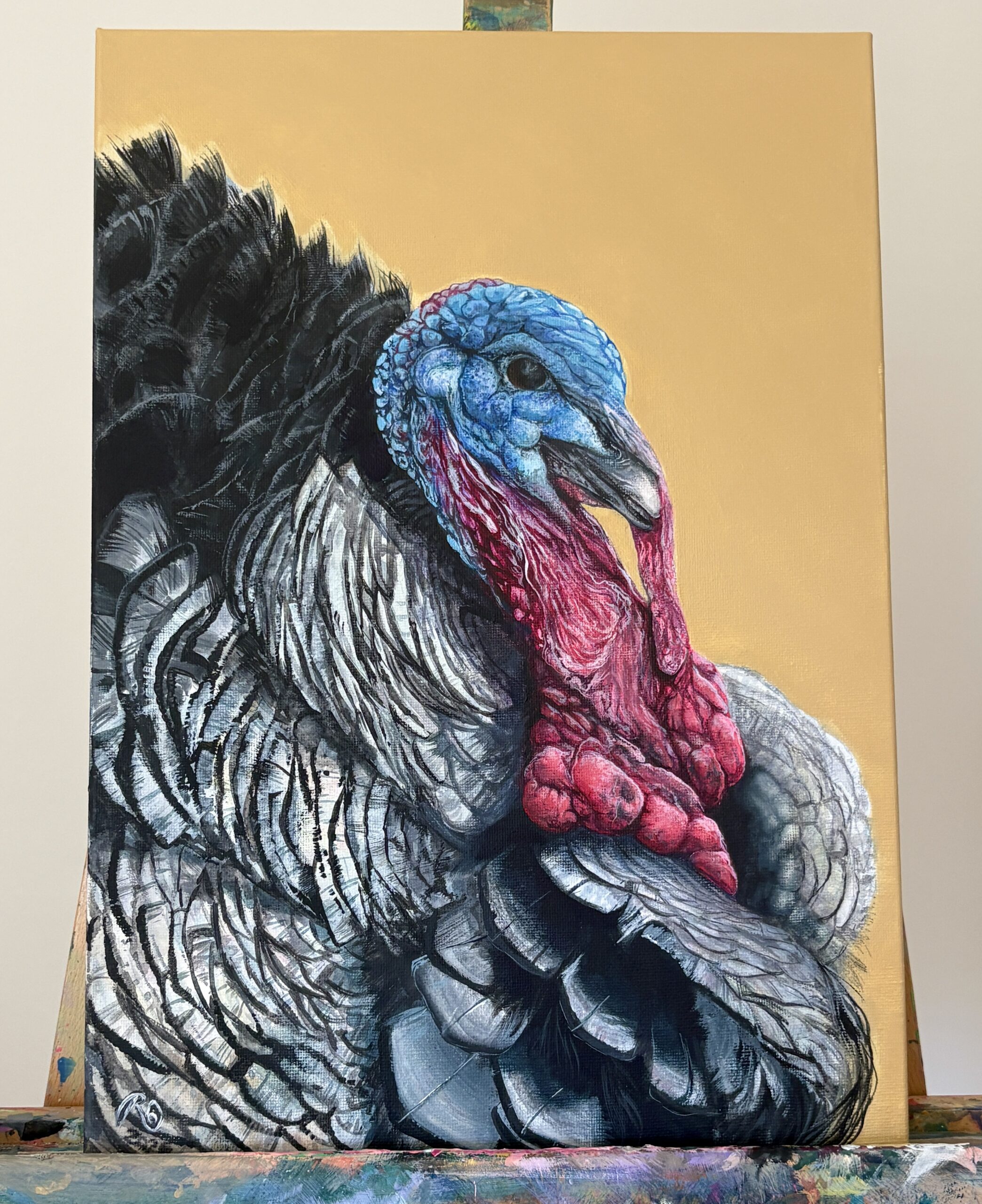 Original turkey portrait Colourful Conversation displayed on an artist's easel.